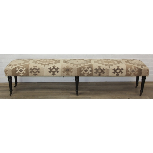 92 - A very large antique style footstool with kilim style top and turned ebonised legs, 220cm x 45cm x 5... 