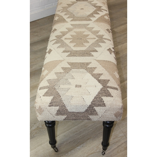 92 - A very large antique style footstool with kilim style top and turned ebonised legs, 220cm x 45cm x 5... 