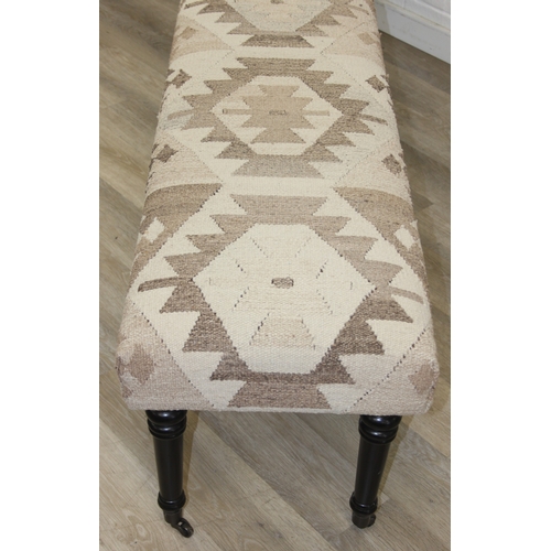 92 - A very large antique style footstool with kilim style top and turned ebonised legs, 220cm x 45cm x 5... 