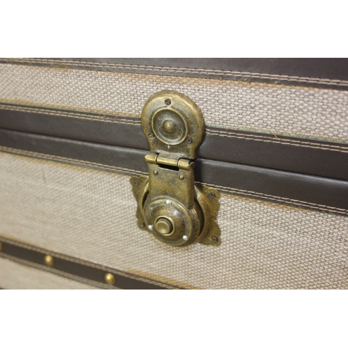 88 - An unusual fabric and faux leather aviator style chest of drawers, a lift up top over two banks of t... 