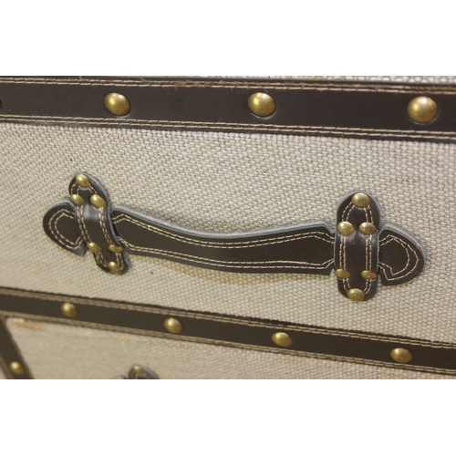 88 - An unusual fabric and faux leather aviator style chest of drawers, a lift up top over two banks of t... 