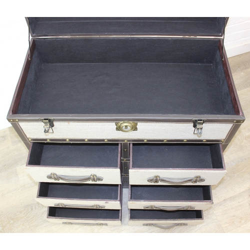 88 - An unusual fabric and faux leather aviator style chest of drawers, a lift up top over two banks of t... 