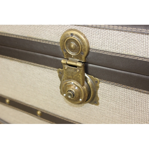 89 - An unusual fabric and faux leather aviator style chest of drawers, a lift up top over two banks of t... 