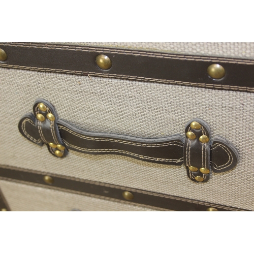 89 - An unusual fabric and faux leather aviator style chest of drawers, a lift up top over two banks of t... 