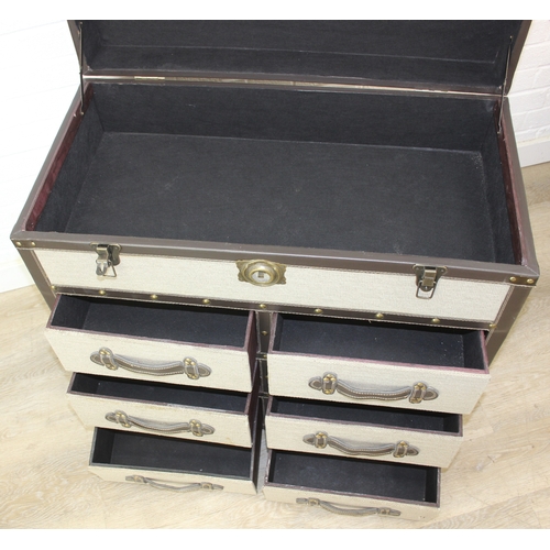 89 - An unusual fabric and faux leather aviator style chest of drawers, a lift up top over two banks of t... 