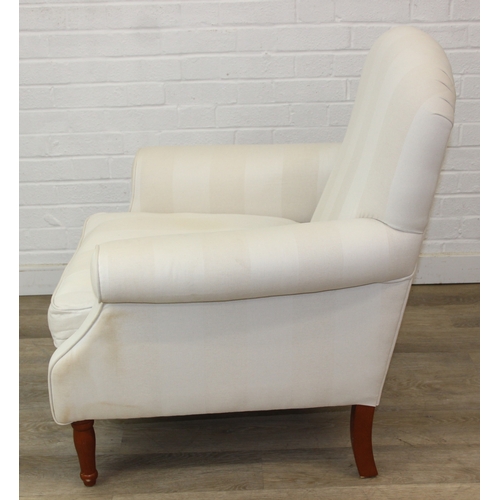 69 - An antique style white and cream striped Victorian style armchair with turned wooden legs, 83cm wide... 
