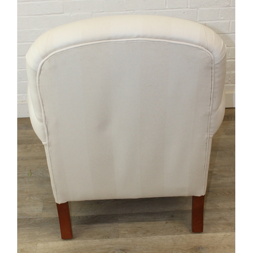 69 - An antique style white and cream striped Victorian style armchair with turned wooden legs, 83cm wide... 