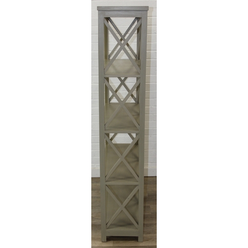 117 - A modern good quality green painted bookcase or display shelves with X fretwork style sides, believe... 