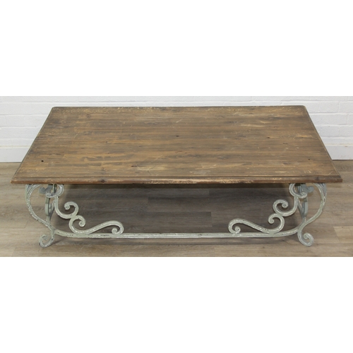 110 - A vintage low table with distressed green painted wrought iron base, the top reclaimed pine, 140cm x... 