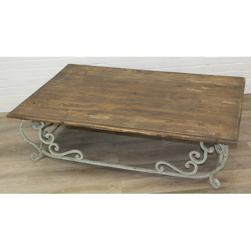 110 - A vintage low table with distressed green painted wrought iron base, the top reclaimed pine, 140cm x... 