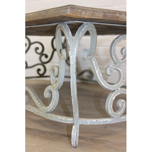 110 - A vintage low table with distressed green painted wrought iron base, the top reclaimed pine, 140cm x... 
