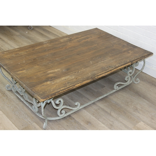 110 - A vintage low table with distressed green painted wrought iron base, the top reclaimed pine, 140cm x... 