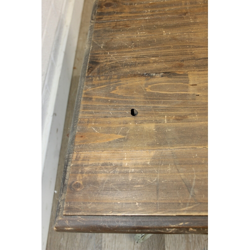 110 - A vintage low table with distressed green painted wrought iron base, the top reclaimed pine, 140cm x... 