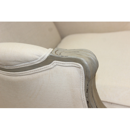 96 - An French style Fauteuil or armchair with distressed mocha coloured painted exposed wooden frame, th... 