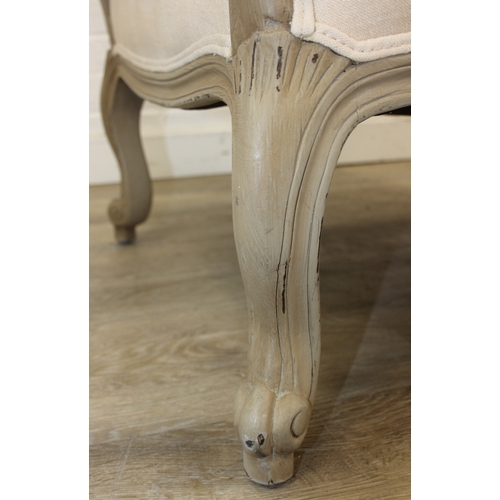 96 - An French style Fauteuil or armchair with distressed mocha coloured painted exposed wooden frame, th... 