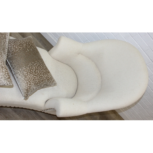 66 - Modern chaise lounge in cream upholstery, raised on blonde wood legs with brass castors, 150cm x 80c... 