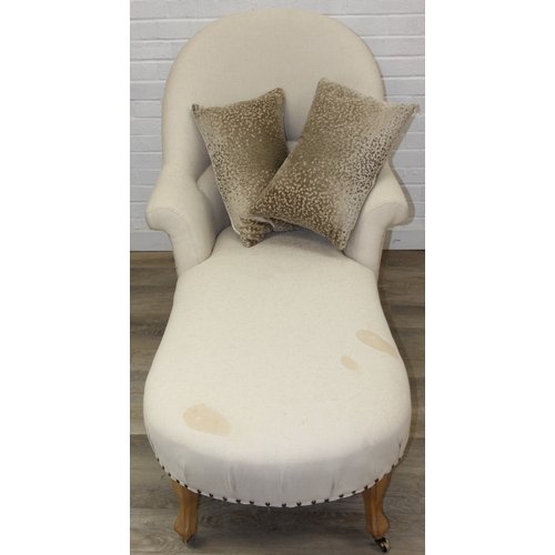 66 - Modern chaise lounge in cream upholstery, raised on blonde wood legs with brass castors, 150cm x 80c... 