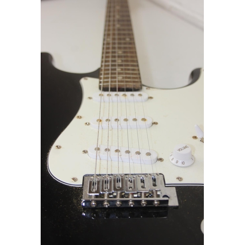 733 - A Burswood electric guitar with black body and soft shell case, 100cm long