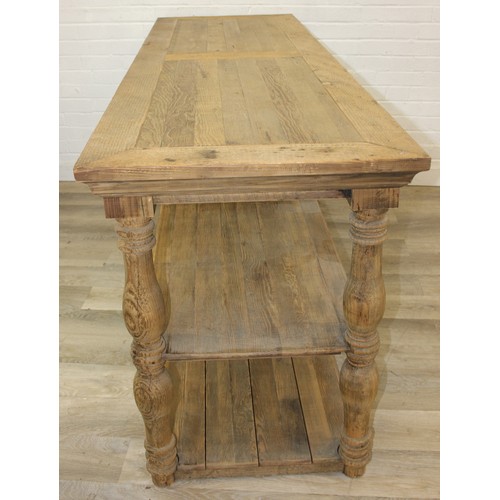 91 - A large rustic reclaimed oak and pine console table or island table with under-tier and turned legs,... 