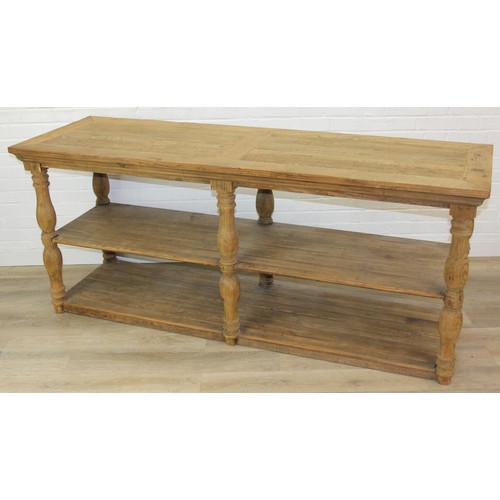 91 - A large rustic reclaimed oak and pine console table or island table with under-tier and turned legs,... 