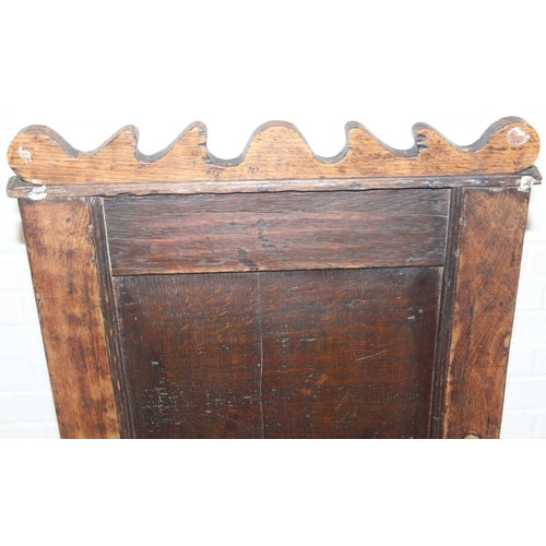 22 - An antique oak Wainscot chair with decorative top rail and carved geometric details to back, in part... 