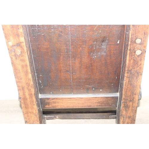 22 - An antique oak Wainscot chair with decorative top rail and carved geometric details to back, in part... 