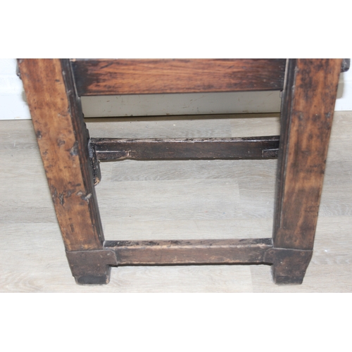 22 - An antique oak Wainscot chair with decorative top rail and carved geometric details to back, in part... 