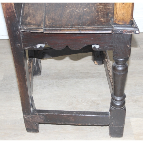 22 - An antique oak Wainscot chair with decorative top rail and carved geometric details to back, in part... 