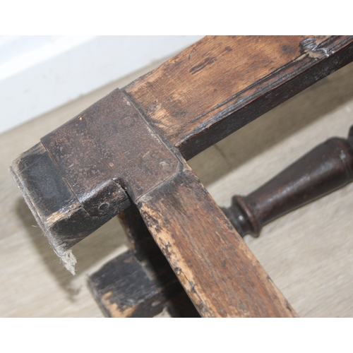 22 - An antique oak Wainscot chair with decorative top rail and carved geometric details to back, in part... 