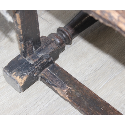 22 - An antique oak Wainscot chair with decorative top rail and carved geometric details to back, in part... 