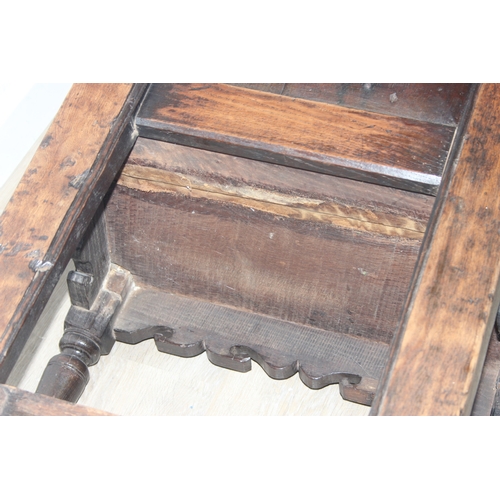 22 - An antique oak Wainscot chair with decorative top rail and carved geometric details to back, in part... 