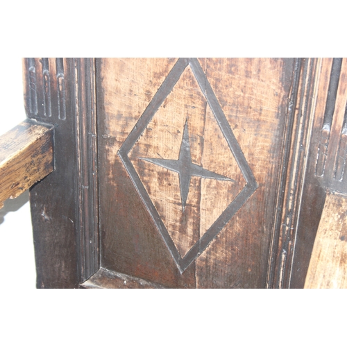 22 - An antique oak Wainscot chair with decorative top rail and carved geometric details to back, in part... 