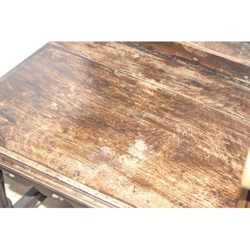 22 - An antique oak Wainscot chair with decorative top rail and carved geometric details to back, in part... 