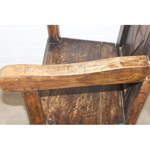 22 - An antique oak Wainscot chair with decorative top rail and carved geometric details to back, in part... 