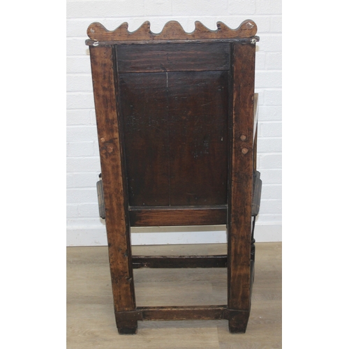 22 - An antique oak Wainscot chair with decorative top rail and carved geometric details to back, in part... 