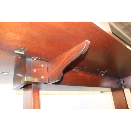 26 - A campaign style mahogany and brass drop leaf low table with brass corners and unusual central compa... 