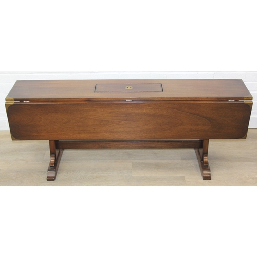 26 - A campaign style mahogany and brass drop leaf low table with brass corners and unusual central compa... 