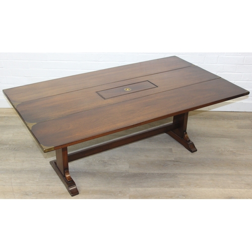 26 - A campaign style mahogany and brass drop leaf low table with brass corners and unusual central compa... 