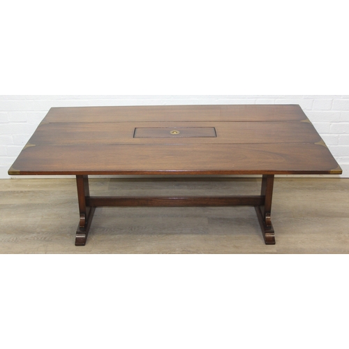 26 - A campaign style mahogany and brass drop leaf low table with brass corners and unusual central compa... 