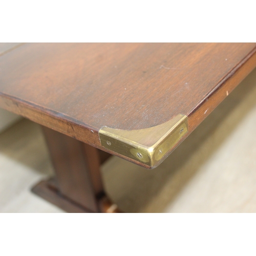 26 - A campaign style mahogany and brass drop leaf low table with brass corners and unusual central compa... 