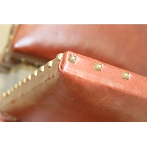 56 - A trio of Carolean style high backed chairs with brown leather seats and backs and studded details, ... 