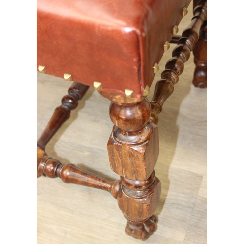 56 - A trio of Carolean style high backed chairs with brown leather seats and backs and studded details, ... 