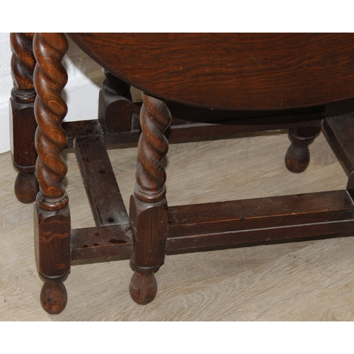 67 - An early 20th century oak dropleaf table with barleytwist supports, 77cm x 41cm (112cm) x 74cm