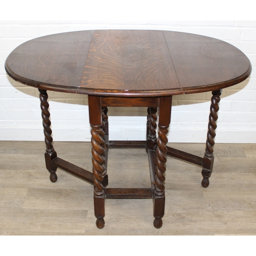 67 - An early 20th century oak dropleaf table with barleytwist supports, 77cm x 41cm (112cm) x 74cm