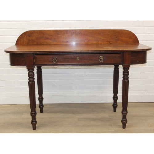 79 - A Regency period mahogany console table with long single drawer, raised back rail, all standing on t... 
