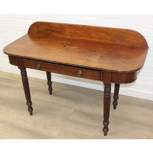 79 - A Regency period mahogany console table with long single drawer, raised back rail, all standing on t... 