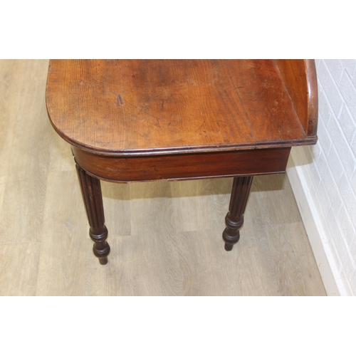 79 - A Regency period mahogany console table with long single drawer, raised back rail, all standing on t... 