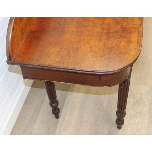79 - A Regency period mahogany console table with long single drawer, raised back rail, all standing on t... 