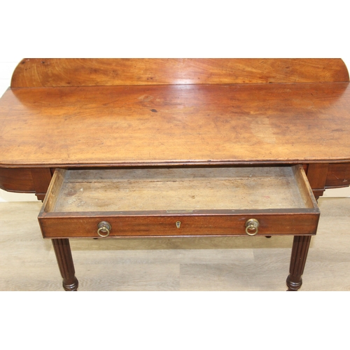 79 - A Regency period mahogany console table with long single drawer, raised back rail, all standing on t... 