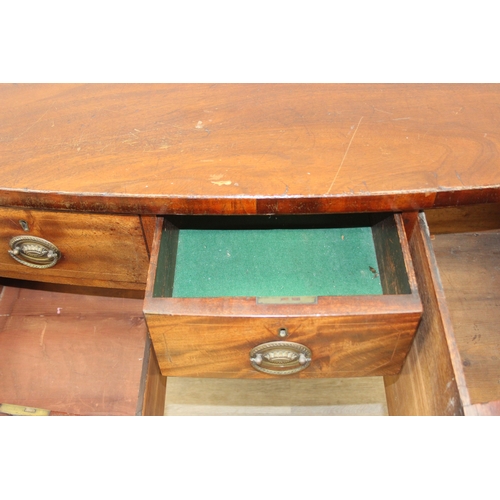 119 - A Regency period mahogany bow fronted sideboard with five drawers and brass handles, 121cm x 68cm x ... 
